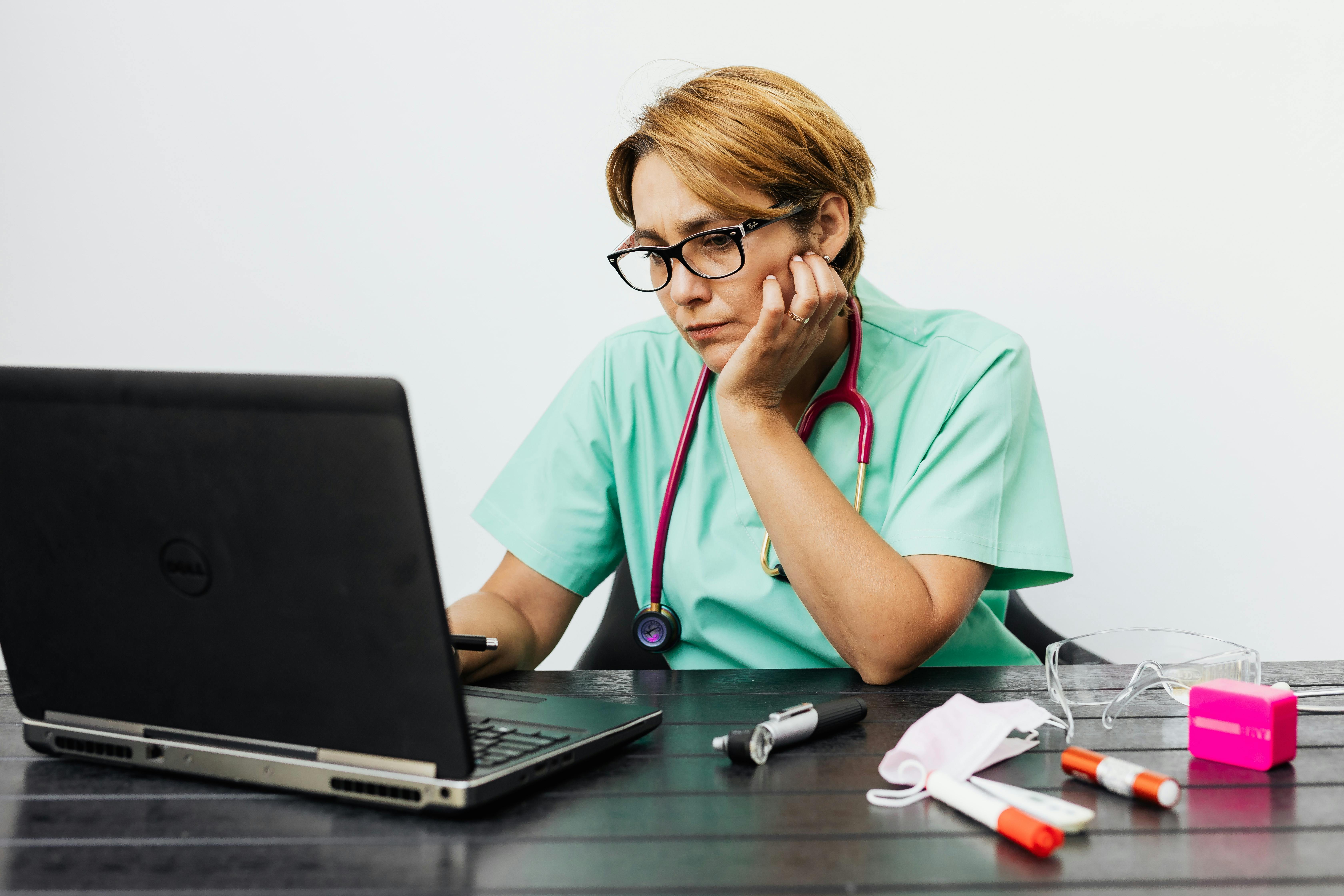 Female doctor busy studying medical reports